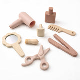 Silicone Hair Stylist Play Set for toddlers including pretend hair dryer, comb, scissors, mirror, straightener, brush, roller and styling bottle.