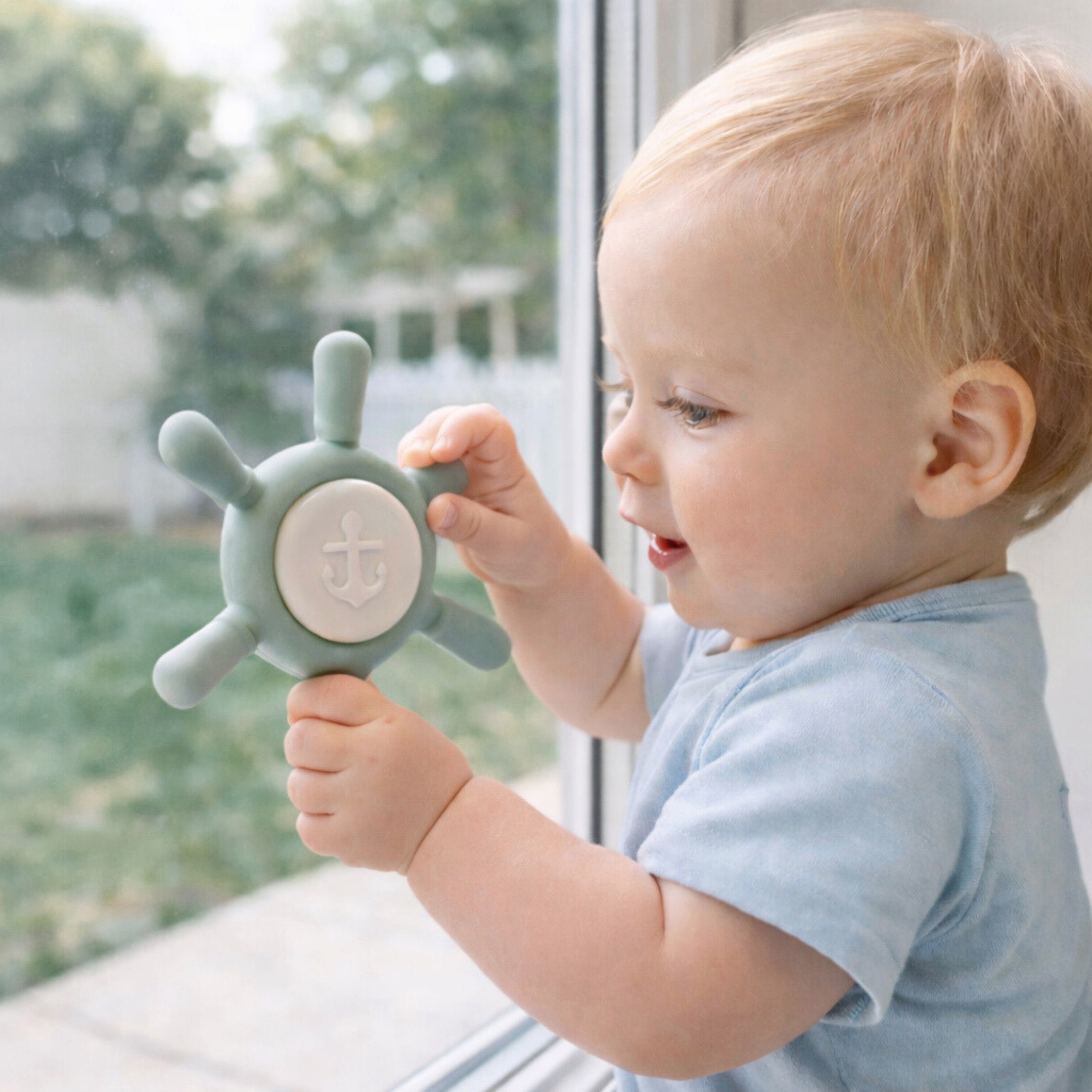 Baby playing with a ahoy sage suction spinner toy by Baby Bliss
