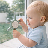 Baby playing with a ahoy sage suction spinner toy by Baby Bliss